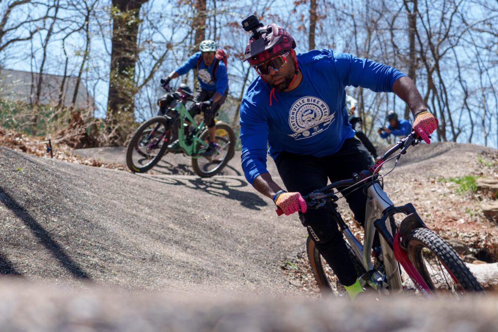 Man riding a mountain bike with a Go Pro camera on his helmet