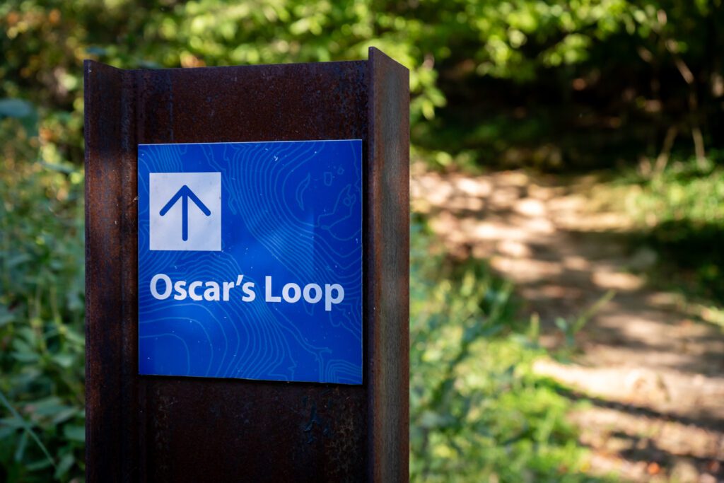 Trail sign reading "Oscar's Loop"