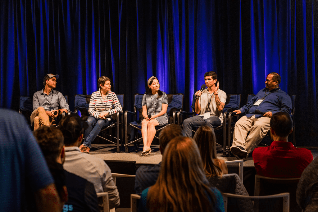 Panel discussion on stage with 5 panelists